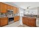 Well-lit kitchen features stone countertops, stainless appliances, and mosaic backsplash at 7511 Hawks Cir, Hanahan, SC 29410