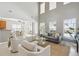 Spacious living room with tall ceilings that seamlessly connects to the kitchen and dining area at 7511 Hawks Cir, Hanahan, SC 29410