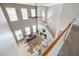 Open living room boasts high ceilings, lots of natural light, and a view of the staircase at 7511 Hawks Cir, Hanahan, SC 29410
