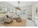 Cozy sunroom with large windows offering lots of natural light and comfortable seating area at 7511 Hawks Cir, Hanahan, SC 29410