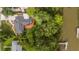 Aerial view of the home showcasing the rooftop deck, lush greenery, and waterfront access at 774 Creekside Dr, James Island, SC 29412