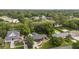 An aerial view of a brick house with a dark roof, lush backyard, and a swimming pool at 774 Creekside Dr, James Island, SC 29412