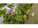 Aerial perspective of the beautiful home with a large deck, surrounded by mature trees and waterfront access with a private dock at 774 Creekside Dr, James Island, SC 29412