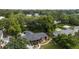 Aerial view of the property featuring a well-maintained yard, deck, and mature trees with water access at 774 Creekside Dr, James Island, SC 29412