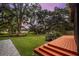 Expansive backyard featuring mature trees, lush lawn, and a wooden deck, perfect for outdoor entertaining at 774 Creekside Dr, James Island, SC 29412