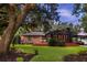 Expansive backyard featuring a spacious deck perfect for outdoor entertaining, surrounded by lush greenery and mature trees at 774 Creekside Dr, James Island, SC 29412