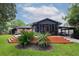 This backyard features a wooden deck, a screened-in porch, and lush landscaping for outdoor enjoyment at 774 Creekside Dr, James Island, SC 29412