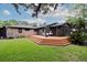 Backyard showcasing a spacious deck, a charming screened-in porch, and a brick exterior for relaxation at 774 Creekside Dr, James Island, SC 29412