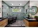 Modern bathroom featuring a sleek soaking tub, dual vanities, and stylish tile work throughout at 774 Creekside Dr, James Island, SC 29412