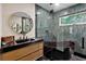 Modern bathroom features a unique black tub, sleek vanity, and stylish tile, creating a spa-like retreat at 774 Creekside Dr, James Island, SC 29412