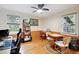 Bright bedroom with hardwood floors, two large windows, and versatile space for work and relaxation at 774 Creekside Dr, James Island, SC 29412