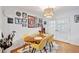 Charming dining area with hardwood floors, gallery wall, and French doors leading to an outdoor space at 774 Creekside Dr, James Island, SC 29412