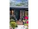 Stylish front door with decorative accents, complemented by brick and vibrant landscaping at 774 Creekside Dr, James Island, SC 29412