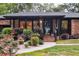 Inviting front entrance with brick steps and lush landscaping surrounding the walkway at 774 Creekside Dr, James Island, SC 29412