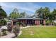 Charming brick home with well-manicured lawn, mature trees, and landscaping at 774 Creekside Dr, James Island, SC 29412