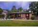 Brick home with inviting front porch, black trim, and well-kept yard at 774 Creekside Dr, James Island, SC 29412