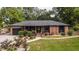 Charming brick home features a well-manicured lawn and beautifully landscaped front yard, creating an inviting curb appeal at 774 Creekside Dr, James Island, SC 29412