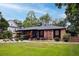 Charming brick home with a lush front lawn and garden, creating a warm and inviting curb appeal at 774 Creekside Dr, James Island, SC 29412