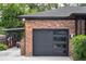 Modern garage with sleek door and a convenient carport attached to a brick exterior at 774 Creekside Dr, James Island, SC 29412