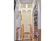 Well-lit hallway with hardwood floors, decorative wainscoting, and access to multiple rooms at 774 Creekside Dr, James Island, SC 29412