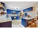 Modern kitchen featuring custom blue cabinets, stainless steel appliances, and marble countertops at 774 Creekside Dr, James Island, SC 29412