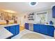 Stylish kitchen with blue cabinetry, stainless steel appliances, and adjoining dining area at 774 Creekside Dr, James Island, SC 29412