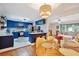 Open-concept kitchen and dining area with blue cabinets and marble countertops at 774 Creekside Dr, James Island, SC 29412