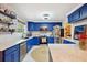 Bright kitchen with custom blue cabinetry, stainless appliances, and stone backsplash at 774 Creekside Dr, James Island, SC 29412