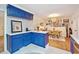Kitchen with blue cabinets, marble countertops, and an adjacent dining space with natural light at 774 Creekside Dr, James Island, SC 29412