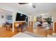 Open floor plan with seamless flow between living room, kitchen, and lounge area, showcasing hardwood floors at 774 Creekside Dr, James Island, SC 29412