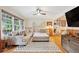 Spacious living room featuring hardwood floors, a sectional sofa, and many bright windows at 774 Creekside Dr, James Island, SC 29412