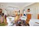 Bright living room with white swivel chairs, modern coffee table, and an open view into the kitchen at 774 Creekside Dr, James Island, SC 29412