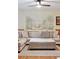 Comfortable living room featuring a large sectional sofa, ottoman, and a scenic mural above the wainscoting at 774 Creekside Dr, James Island, SC 29412