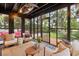 Comfortable screened porch with stylish furnishings and a serene view of the green backyard at 774 Creekside Dr, James Island, SC 29412
