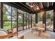 Relaxing screened porch with views of the lush backyard, featuring cozy seating and a ceiling fan at 774 Creekside Dr, James Island, SC 29412