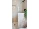 Close-up of the elegant shower with herringbone tile, a built-in niche, and modern fixtures at 774 Creekside Dr, James Island, SC 29412