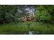 Scenic water view with lush greenery, showcasing a charming home with outdoor entertaining space and string lights at 774 Creekside Dr, James Island, SC 29412