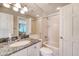 Bright bathroom featuring granite vanity and shower-tub combination at 930 Sealoft Villa Dr, Seabrook Island, SC 29455