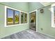 Charming outdoor deck featuring multiple windows and a door with a view of lush greenery at 930 Sealoft Villa Dr, Seabrook Island, SC 29455