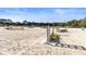 A well-maintained horse arena with sandy ground and several jumps set against a clear blue sky at 930 Sealoft Villa Dr, Seabrook Island, SC 29455
