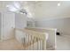 Carpeted loft with vaulted ceilings and a white railing overlooking the floor below at 930 Sealoft Villa Dr, Seabrook Island, SC 29455