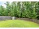 Lush, green backyard with a wooden fence and a small playhouse for outdoor enjoyment at 9836 Black Tupelo Ln, Ladson, SC 29456