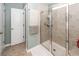 Bathroom featuring a glass-enclosed shower, neutral tile and flooring, and white door at 9836 Black Tupelo Ln, Ladson, SC 29456