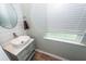 Modern powder room with a vessel sink, brushed nickel faucet, and shiplap accent wall near a window at 9836 Black Tupelo Ln, Ladson, SC 29456