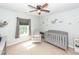 Adorable Bedroom with a crib, glider chair, and nautical-themed decorations on the walls at 9836 Black Tupelo Ln, Ladson, SC 29456