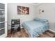 Comfortable bedroom featuring modern decor, wood-look floors, soft lighting, and a unique accent wall at 9836 Black Tupelo Ln, Ladson, SC 29456