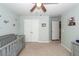 Bright Bedroom with a closet, a gray crib, and soft, neutral-colored walls at 9836 Black Tupelo Ln, Ladson, SC 29456