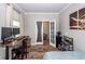 Versatile room with wood-look floors, an adjustable desk, and convenient access to another room through a glass paneled door at 9836 Black Tupelo Ln, Ladson, SC 29456