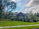 Exterior shot of the community lodge showing the beautifully landscaped surroundings at 9836 Black Tupelo Ln, Ladson, SC 29456