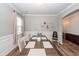 Light-filled dining room with a large table, decorative shelving, wainscotting and ample space for Gathering meals at 9836 Black Tupelo Ln, Ladson, SC 29456